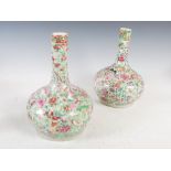 A pair of Chinese porcelain celadon ground famille rose bottle vases, Qing Dynasty, decorated in