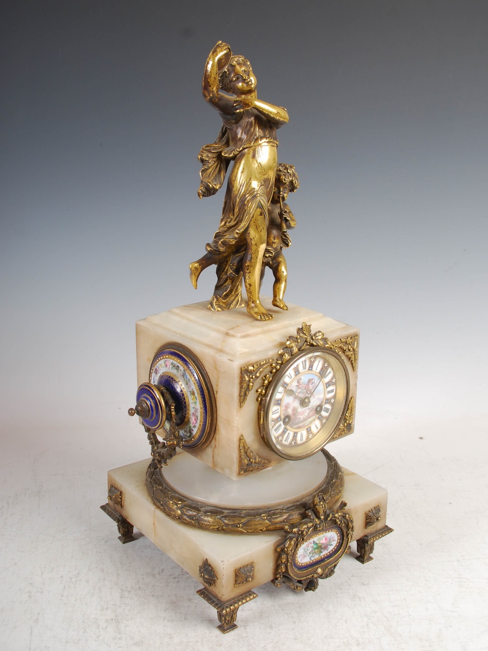 A late 19th century French onyx ormolu and porcelain mounted mantel clock, the blue ground porcelain