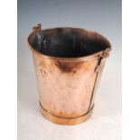 An early 20th century copper bucket, of tapered cylindrical form with swing handle, 26cm diameter