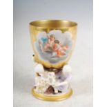 A late 19th/early 20th century Continental porcelain goblet, the richly gilded bowl decorated with a