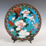 A Japanese blue ground cloisonne dish, Meiji Period, decorated with peony, chrysanthemum and two