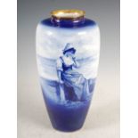 A Royal Doulton blue and white porcelain vase, decorated with Dutch girl sitting on sea wall,