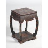 A Chinese lacquered stool, late 19th/ early 20th century, the square top on four concave supports