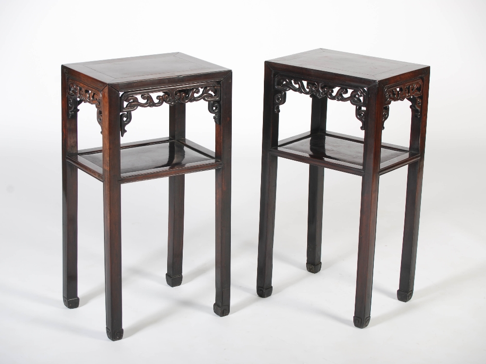 A pair of Chinese dark wood jardiniere stands, Qing Dynasty, the rectangular panelled tops above