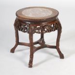 A Chinese dark wood jardiniere stand, Qing Dynasty, the circular top with mottled red and white