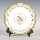 A French Limoges hand painted cabinet plate, decorated with a circular panel enclosing a cock