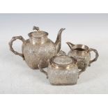 A Chinese silver three piece tea set, Qing Dynasty, comprising; teapot, twin handled sugar bowl