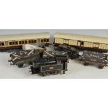 A collection of O gauge railway train, carriages, wagons and track, comprising; clockwork locomotive