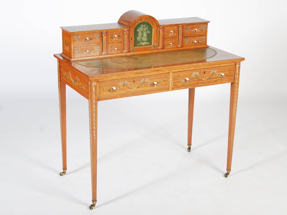 An Edwardian painted satinwood writing table, the rectangular top with a green tooled leather