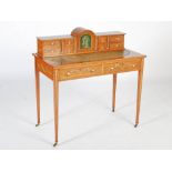 An Edwardian painted satinwood writing table, the rectangular top with a green tooled leather