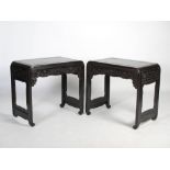 A pair of heavy Chinese dark wood writing tables, Qing Dynasty, the panelled rectangular tops