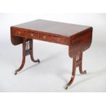 A 19th century mahogany and calamander banded sofa table, the rectangular top with twin drop leaves,