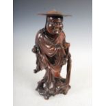 A Chinese carved wood figure group, Qing Dynasty, with inlaid eyes and teeth, 39cm high.