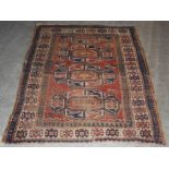 A Kazak rug and a Persian rug, late 19th/ early 20th century, the Kazak rug with a madder ground and