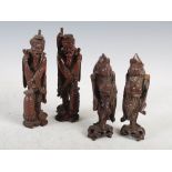 Two pairs of Chinese carved wood figure groups, Qing Dynasty, one pair carved as sage figures