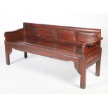 A Chinese dark wood bench, late Qing Dynasty, the upright back with four rectangular panels above