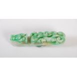 A Chinese spinach jade belt buckle, Qing Dynasty, carved with two dragons, 7.5cm long x 1.5cm wide.