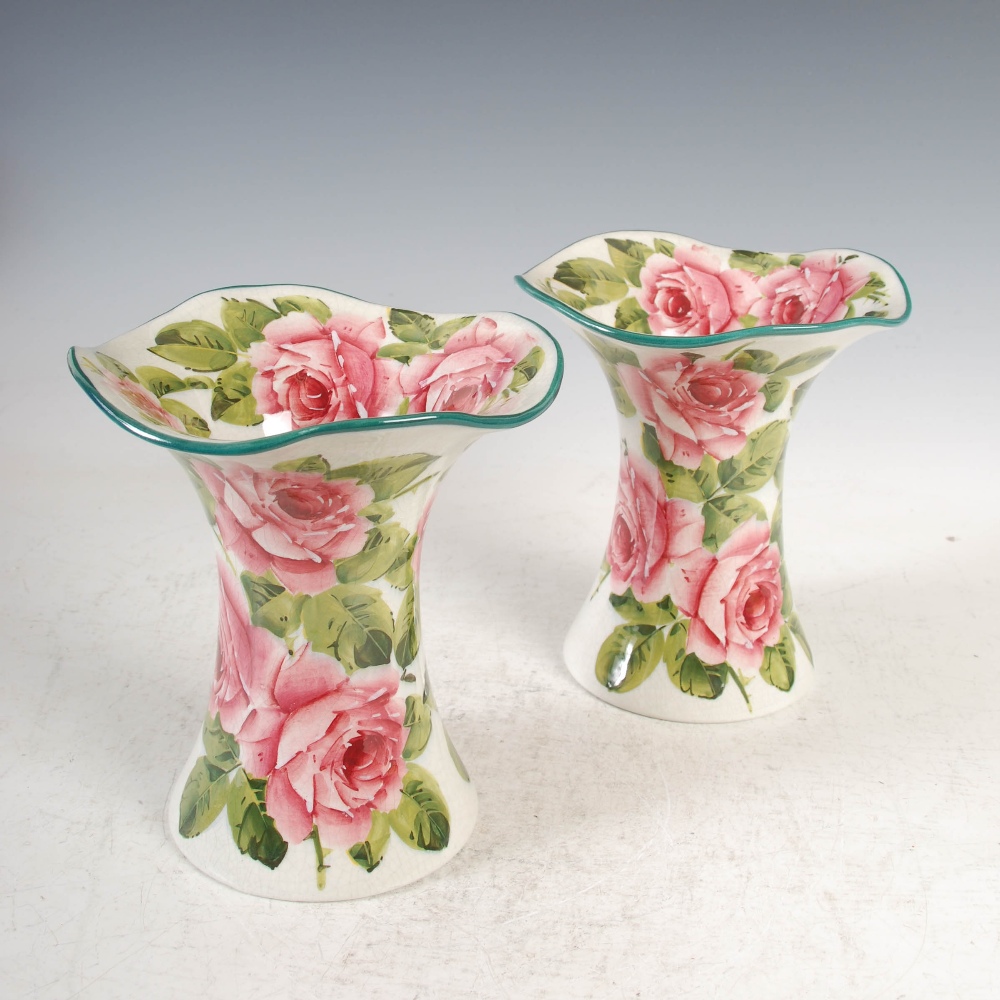 A pair of Wemyss pottery Lady Eva vases, decorated with roses and foliage with green line rims,