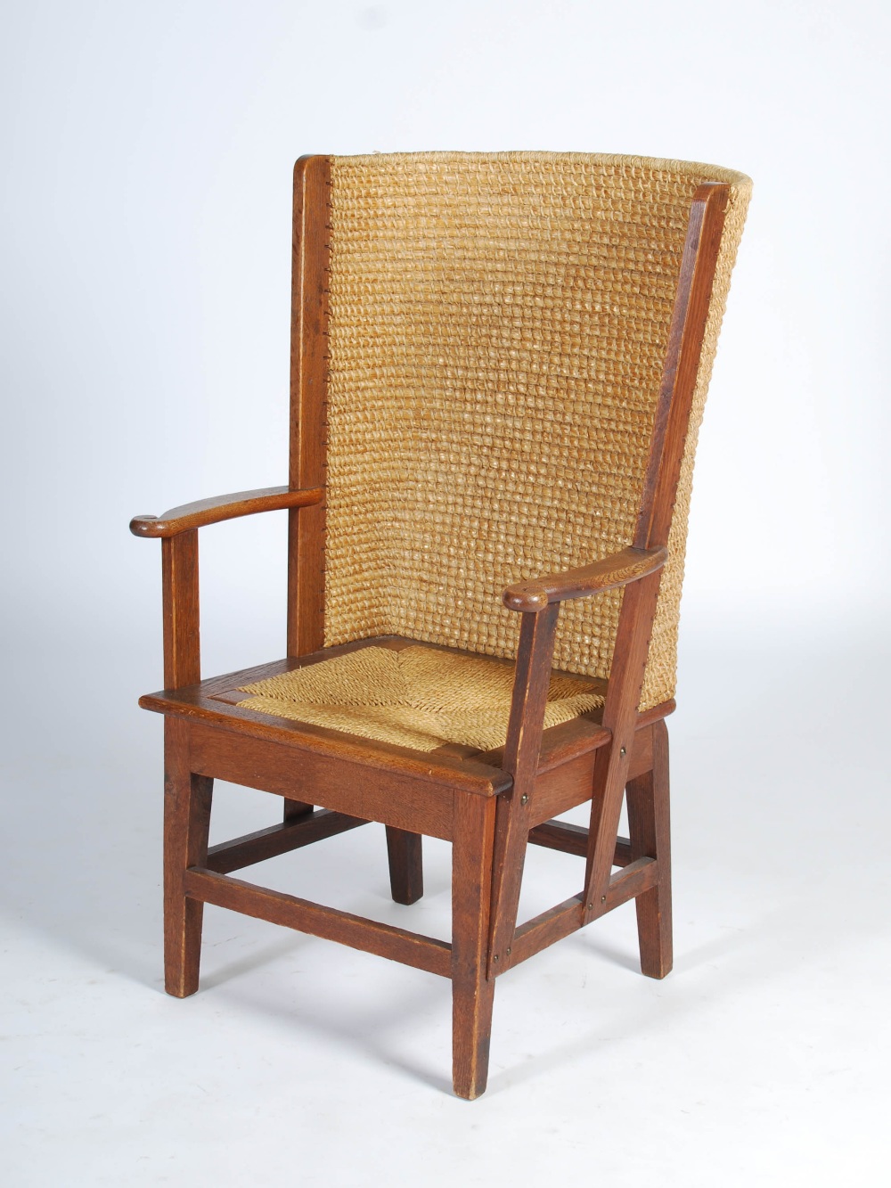 A late 19th/early 20th century oak Orkney chair, with woven back and woven drop in seat, raised on