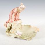 A Royal Dux porcelain Art Nouveau figure group of maiden kneeling on rock looking into a pool,