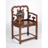 A Chinese dark wood armchair, late 19th/early 20th century, the shaped top rail above a splat carved