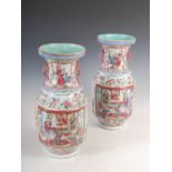 A pair of Chinese porcelain famille rose Canton vases, Qing Dynasty, decorated with panels of