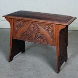 An Arts & Crafts oak stool, the hinged rectangular top with an embossed leather seat pad, above a