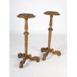 A pair of late 19th/early 20th century Continental gilt wood jardiniere stands, the circular tops