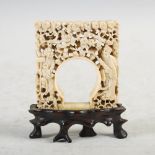 A Chinese carved ivory panel, Qing Dynasty, carved with a central arch flanked by pierced and carved