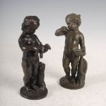 A pair of bronze cherubs, one modelled standing holding a bird, the other modelled standing