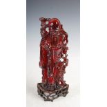 AMENDMANT, NOT AMBER AS CATALOGUED BUT SIMULATED AMBER - A Chinese amber figure of Shou Loa and