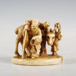 A Japanese Ivory okimono of elderly farmer, stag and attendant boy, Meiji Period, signed on red