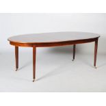 A mahogany and satinwood banded oval extending dining table, enclosing one additional leaf, raised