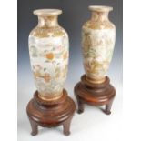 A large pair of Satsuma pottery vases on carved dark wood stands, Meiji Period, decorated with