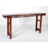 A Chinese dark wood altar table, the rectangular panelled top above a frieze carved with scrolls,