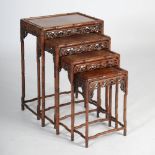 A quartetto of Chinese dark wood occasional tables, late Qing Dynasty, the rectangular panelled tops