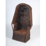 A 20th century wicker hooded chair, 139cm high x 77cm wide x 64cm deep.
