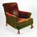 A Victorian mahogany green velvet and carpet upholstered armchair, raised on scroll carved