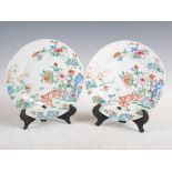 A pair of Chinese porcelain famille rose plates, Qing Dynasty, decorated with fenced gardens of rock
