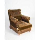 A Victorian mahogany carpet upholstered armchair, raised on tapered cylindrical supports with