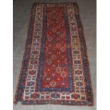 A Kazak runner, late 19th/ early 20th century, the rectangular madder ground decorated with