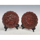 A pair of Chinese cinnabar lacquer flower-shaped dishes, Qing Dynasty, carved with dragons and