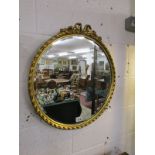 Circular gilt framed and bevelled glass wall mirror