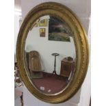 Oval gilt-framed & bevelled wall mirror