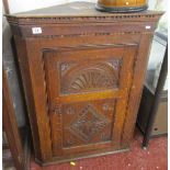 Antique corner cupboard, with carved panel door