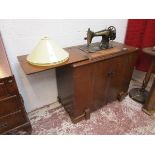 Singer sewing machine on stand with cabinet