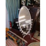 Large metal framed mirror on stand