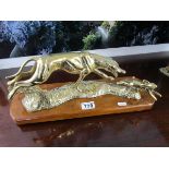 Brass dog and hare figurine on wooden base