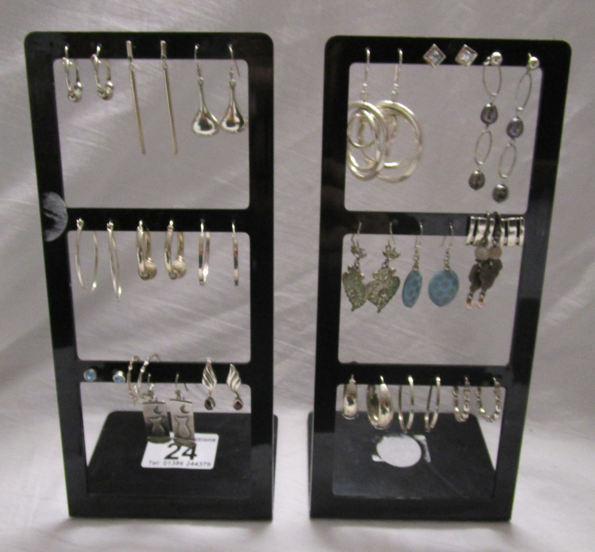 Silver earrings on 2 display stands
