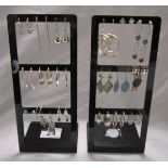 Silver earrings on 2 display stands